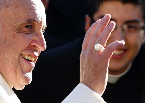 Pope Francis, who's 78th birthday is today, waves as he arrives to lead his general audience at the Vatican