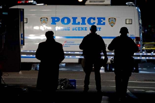 Police standby at the location where two NYPD officers were shot dead in Brooklyn, New York
