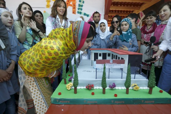 Nobel Peace Prize laureate Malala Yousafzai blows out candles on her birthday cake at a school for Syrian refugee girls, built by the NGO Kayany Foundation, in Lebanon's Bekaa Valley