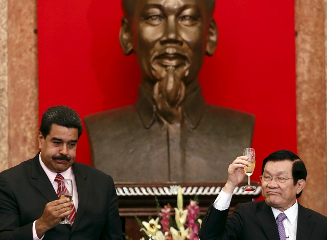 Venezuela's President Nicolas Maduro and his Vietnamese counterpart Truong Tan Sang drink wine after a signing ceremony at the Presidential Palace in Hanoi, Vietnam