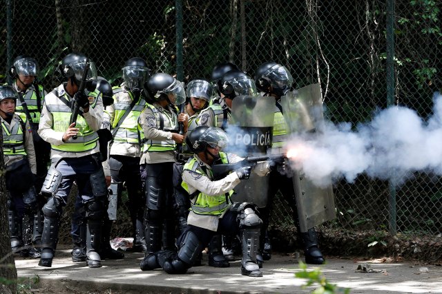 A riot police fires tear gas towards demonstrators during a protest called by university students against Venezuela's government in Caracas