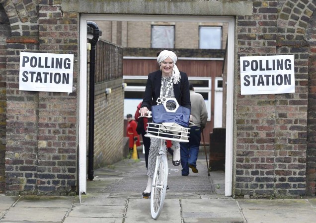 A woman cycles out of a polling station for the Referendum on the European Union in Chelsea, London, Britain, June 23, 2016. REUTERS/Toby Melville