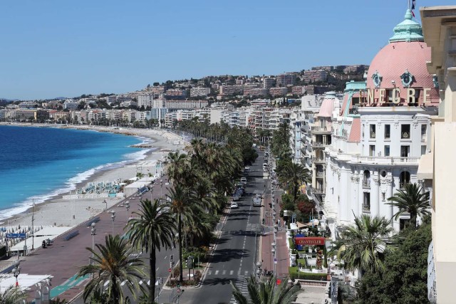 This picture taken on July 15, 2016, shows the site where a truck drove into a crowd watching a fireworks display on the Promenade des Anglais seafront near the Negresco Hotel in the French Riviera town of Nice on July 15, 2016. An attack in Nice where a man rammed a truck into a crowd of people left 84 dead and another 18 in a "critical condition", interior ministry spokesman Pierre-Henry Brandet said Friday. An unidentified gunman barrelled the truck two kilometres (1.3 miles) through a crowd that had been enjoying a fireworks display for France's national day before being shot dead by police.  / AFP PHOTO / Valery HACHE