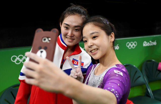 REFILE - CORRECTING ID OF SOUTH KOREAN ATHLETE 2016 Rio Olympics - Gymnastics training - Rio Olympic Arena - Rio de Janeiro, Brazil - 04/08/2016. Lee Eun-Ju (KOR) of South Korea (R) takes a selfie picture with Hong Un Jong (PRK) of North Korea. REUTERS/Dylan Martinez TPX IMAGES OF THE DAY. FOR EDITORIAL USE ONLY. NOT FOR SALE FOR MARKETING OR ADVERTISING CAMPAIGNS.