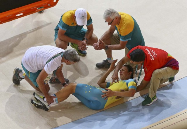 2016 Rio Olympics - Cycling Track - Preliminary - Team training - Rio Olympic Velodrome - Rio de Janeiro, Brazil - 08/08/2016. Australia (AUS) women's team member Melissa Hoskins is aided after a crash during a practice session.  REUTERS/Paul Hanna   FOR EDITORIAL USE ONLY. NOT FOR SALE FOR MARKETING OR ADVERTISING CAMPAIGNS.