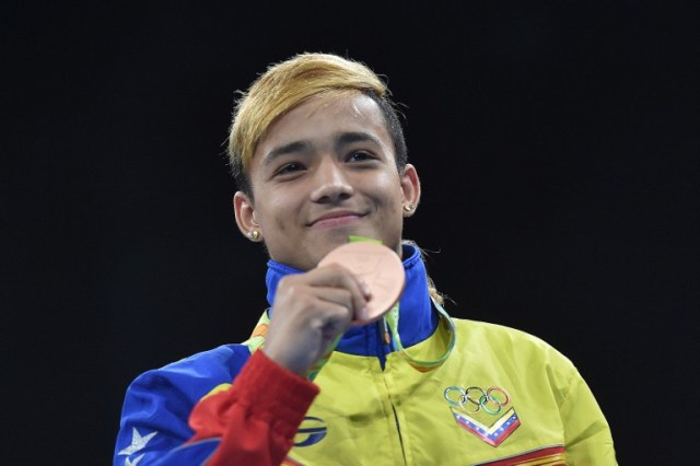 Bronze medalists Venezuela's Yoel Segundo Finol react during the medal presentation ceremony following the Men's Fly (52kg) Final Bout at the Rio 2016 Olympic Games at the Riocentro - Pavilion 6 in Rio de Janeiro on August 21, 2016. / AFP PHOTO / YURI CORTEZ