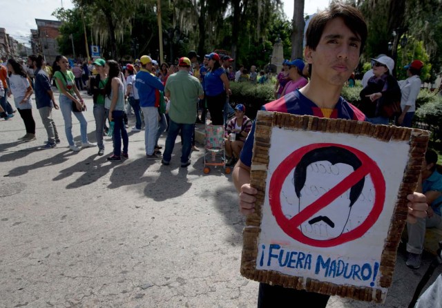 Un joven sostiene un cartel contra el presidente de Venezuela Nicolás Maduro durante una protesta en Mérida, Venezuela, el miércoles 7 de septiembre de 2016.  (AP Foto/Fernando Llano)