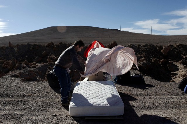 A worker from Escondida, the world's biggest copper mine, makes the bed as they prepare to camp outside the company gates during a strike, in Antofagasta, Chile February 9, 2017. REUTERS/Juan Ricardo EDITORIAL USE ONLY. NO RESALES. NO ARCHIVE
