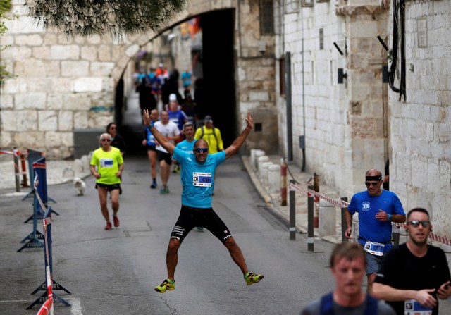 Athletes run inside Jerusalem's Old City during the seventh International Jerusalem Marathon March 17, 2017. REUTERS/Ronen Zvulun