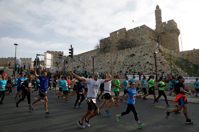 Athletes run outside Jerusalem's Old City during the seventh International Jerusalem Marathon March 17, 2017. REUTERS/Ronen Zvulun