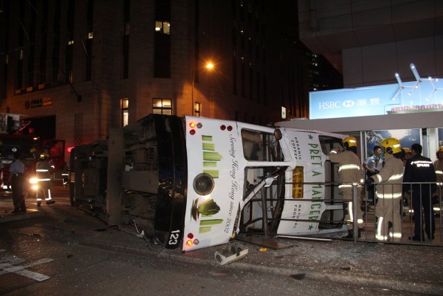 Rescuers check a double decker tram after it overturned at the Central district in Hong Kong, China, early April 6, 2017. The 23-year-old tram driver was arrested on suspicion of dangerous driving in the accident which injured 14 people, local media reported. REUTERS/Apple Daily ATTENTION EDITORS - THIS PICTURE WAS PROVIDED BY A THIRD PARTY. FOR EDITORIAL USE ONLY. TAIWAN OUT. NO COMMERCIAL OR EDITORIAL SALES IN TAIWAN. HONG KONG OUT. NO COMMERCIAL OR EDITORIAL SALES IN HONG KONG. TEMPLATE OUT. NO ONLINE USE. NOT FOR SALE FOR INTERNET DISPLAY. TEMPLATE OUT.