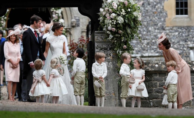 Britain's Catherine, Duchess of Cambridge stands with her son Prince George as she looks across at Pippa Middleton and James Matthews after their wedding at St Mark's Church in Englefield, Britain May 20, 2017. Pippa Middleton is the sister of Catherine, Duchess of Cambridge.  REUTERS/Kirsty Wigglesworth/Pool