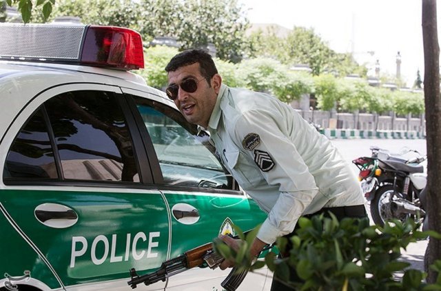 An Iranian policeman takes cover during an attack on the Iranian parliament in central Tehran, Iran, June 7, 2017. Tasnim News Agency/Handout via REUTERS ATTENTION EDITORS - THIS PICTURE WAS PROVIDED BY A THIRD PARTY. FOR EDITORIAL USE ONLY. NO RESALES. NO ARCHIVE.