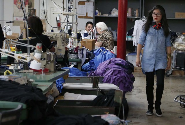 Venezuelan artist and designer Lisu Vega walks through a warehouse where her clothes for her line "Resistance" are being sewn in Miami, Florida on June 8, 2017. The models are dressed in scenes of violence in Caracas and handkerchiefs representing the rags used by protesters to protect themselves from police tear gas. It is the "Resistance" collection of Venezuelan fashion designer Lisu Vega. / AFP PHOTO / RHONA WISE