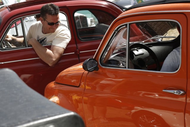 An enthusiast looks on during the 34th International Rally of Fiat 500 Club Italia for the 60th anniversary of this car on July 8, 2017, in Garlenda, near Genoa.   More than 1200 cars came from Europe to take part at the 34 rally of Garlenda to celebrate the 60th anniversary of the Fiat 500.  / AFP PHOTO / Marco BERTORELLO