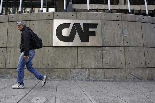 A man walks past the corporate logo of the Development Bank of Latin America (CAF) at its headquarters in Caracas, Venezuela, December 22, 2015. An explosive device of minor intensity went off at the headquarters of CAF causing only material damage, according to local media. REUTERS/Carlos Garcia Rawlins  - RTX1ZREB