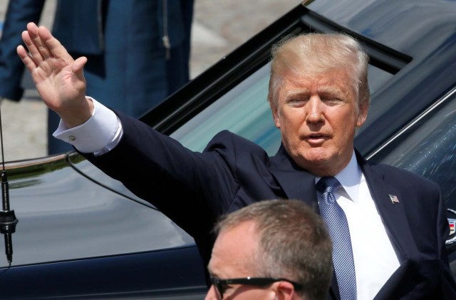 U.S. President Donald Trump waves at the end of the traditional Bastille Day military parade on the Champs-Elysees in Paris, France, July 14, 2017. REUTERS/Gonzalo Fuentes