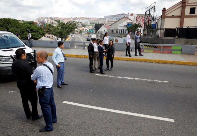 Forensic technicians stand at a crime scene where, according to the opposition, gunmen "apparently" shot dead and wounded several people during an opposition-organised unofficial plebiscite against President Nicolas Maduro's government and his plan to rewrite the constitution, in Caracas, Venezuela July 16, 2017. REUTERS/Carlos Garcia Rawlins