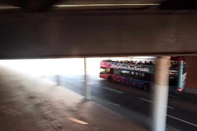 A touristic bus of Barcelona passes under a tunnel in Barcelona on August 21, 2017. Spanish police said on August 21, 2017 that they have identified the driver of the van that mowed down pedestrians on the busy Las Ramblas boulevard in Barcelona, killing 13. The 22-year-old Moroccan is believed to be the last remaining member of a 12-man cell still at large in Spain or abroad, with the others killed by police or detained over last week's twin attacks in Barcelona and the seaside resort of Cambrils that claimed 14 lives, including a seven-year-old boy. / AFP PHOTO / Josep LAGO