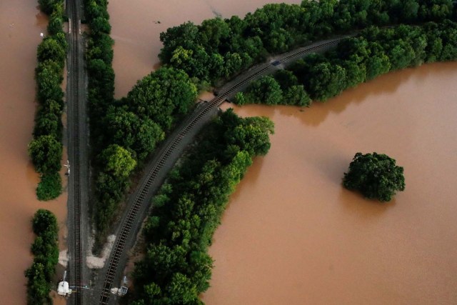 Railway lines are seen surrounded by flood waters caused by Tropical Storm Harvey near Sandy Point, Texas, U.S. August 30, 2017. Picture taken August 30, 2017. REUTERS/Adrees Latif     TPX IMAGES OF THE DAY