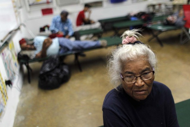 Pilar Gonzalez sits on a cot at a shelter as Hurricane Maria approaches Puerto Rico in Fajardo on September 19, 2017. Maria headed towards the Virgin Islands and Puerto Rico after battering the eastern Caribbean island of Dominica, with the US National Hurricane Center warning of a "potentially catastrophic" impact. / AFP PHOTO / Ricardo ARDUENGO