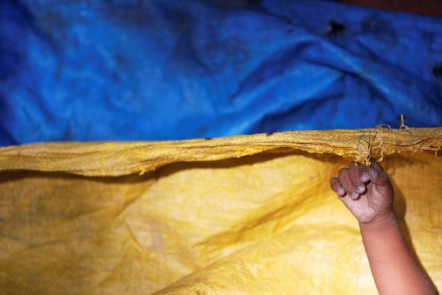 ATTENTION EDITORS - VISUAL COVERAGE OF SCENES OF INJURY OR DEATH A hand of one of Rohingya refugee children from Myanmar who were killed when their boat capsized on the way to Bangladesh, is seen under the plastic sheeting used to cover bodies of victims brought to a local Islamic school in Shah Porir Dwip, in Teknaf, near Cox's Bazar in Bangladesh, October 9, 2017. REUTERS/Damir Sagolj TEMPLATE OUT