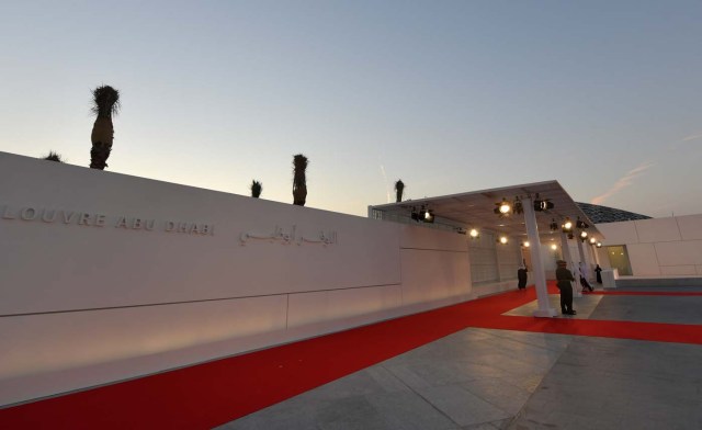 Security stand at the entrance to the Louvre Abu Dhabi prior to the inauguration of the museum on November 8, 2017. More than a decade in the making, the Louvre Abu Dhabi is opening its doors bringing the famed name to the Arab world for the first time. / AFP PHOTO / Giuseppe CACACE