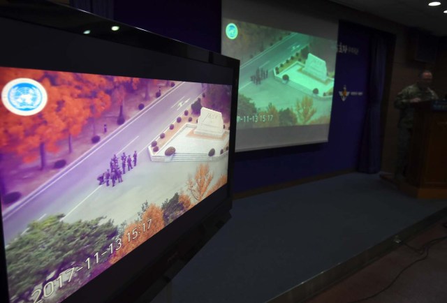 United Nations Command spokesman Colonel Chad G. Carroll shows a surveillance TV footage containing the moment of defection of a North Korean Soldier, during a press briefing at the Defence Ministry in Seoul on November 22, 2017. A North Korean soldier crossed the border into the South in breach of a 1953 armistice agreement as he pursued a defector who was shot last week, the US-led United Nations Command (UNC) said on November 22. / AFP PHOTO / JUNG Yeon-Je