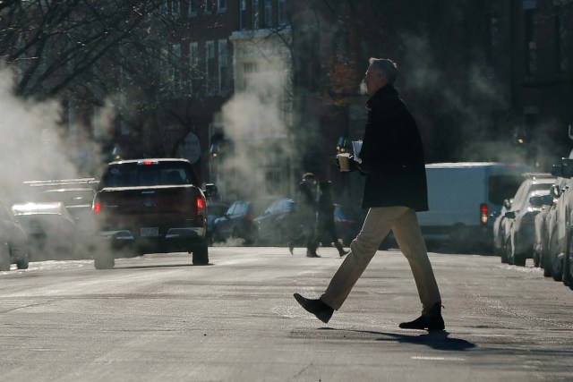 A man crosses the street on a cold winter morning in Boston, Massachusetts, U.S., January 2, 2018. REUTERS/Brian Snyder