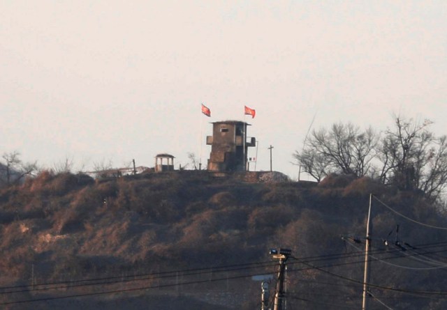 A North Korean flag flutters on the top of their guard post inside North Korean territory in this picture taken near the demilitarized zone separating the two Koreas in Paju, South Korea, January 3, 2018. REUTERS/Kim Hong-Ji