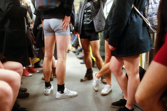 People take part in the annual flash mob "No Pants Subway Ride" in Berlin, Germany, January 7, 2018. REUTERS/Hannibal Hanschke
