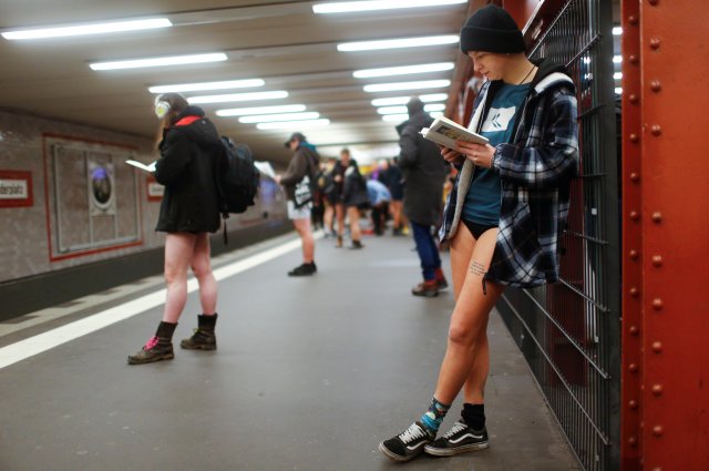 People take part in the annual flash mob "No Pants Subway Ride" in Berlin, Germany, January 7, 2018. REUTERS/Hannibal Hanschke