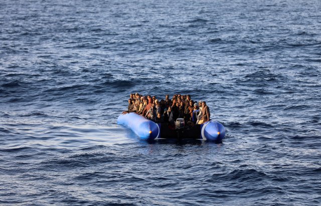 Migrants in a dinghy are rescued by Libyan coast guards off the coast of Garabulli, east of Tripoli, Libya, January 8, 2018. REUTERS/Hani Amara