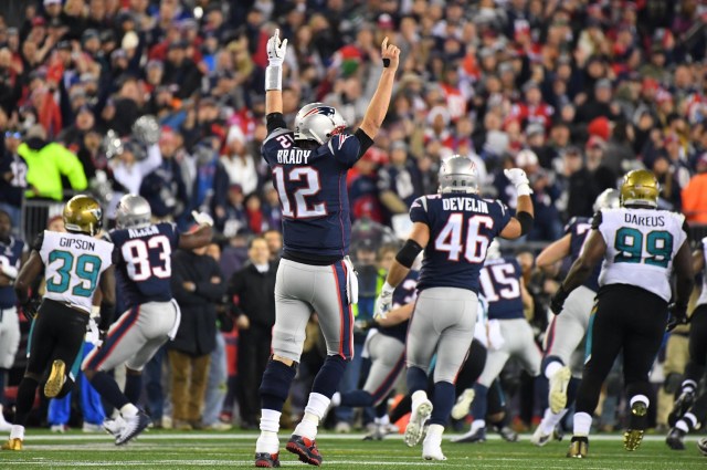 Jan 21, 2018; Foxborough, MA, USA; New England Patriots quarterback Tom Brady (12) celebrates after a first down by running back Dion Lewis (33) picks up a first down in the fourth quarter in the AFC Championship Game against the Jacksonville Jaguars at Gillette Stadium. Mandatory Credit: Robert Deutsch-USA TODAY Sports TPX IMAGES OF THE DAY