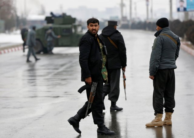 Afghan policemen keep watch near the site of an attack at the Marshal Fahim military academy in Kabul, Afghanistan January 29, 2018.REUTERS/Mohammad Ismail