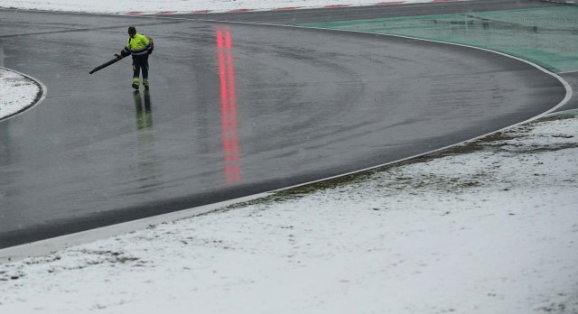 F1 Formula One - Formula One Test Session - Circuit de Barcelona-Catalunya, Montmelo, Spain - February 28, 2018 A worker clears snow from the track before testing REUTERS/Albert Gea