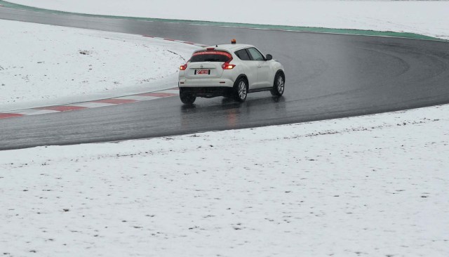 F1 Formula One - Formula One Test Session - Circuit de Barcelona-Catalunya, Montmelo, Spain - February 28, 2018 Race control check the track surrounded by snow before testing REUTERS/Albert Gea