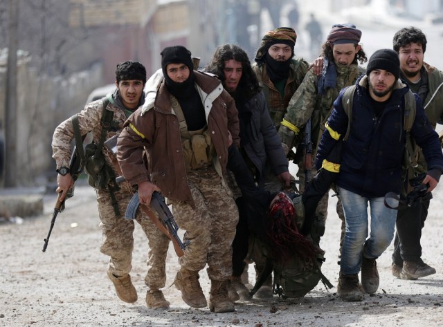 ATTENTION EDITORS - VISUAL COVERAGE OF SCENES OF INJURY OR DEATH  Turkish-backed Free Syrian Army fighters carry their wounded colleague in Rajo, Syria March 3, 2018. REUTERS/Khalil Ashawi   TEMPLATE OUT